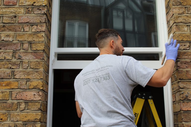 Wandsworth Sash Windows installer fitting a sash window on a Victorian terraced property in Barons Court