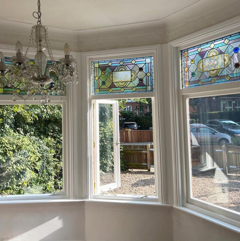 Internal view of timber casement windows with stained glass