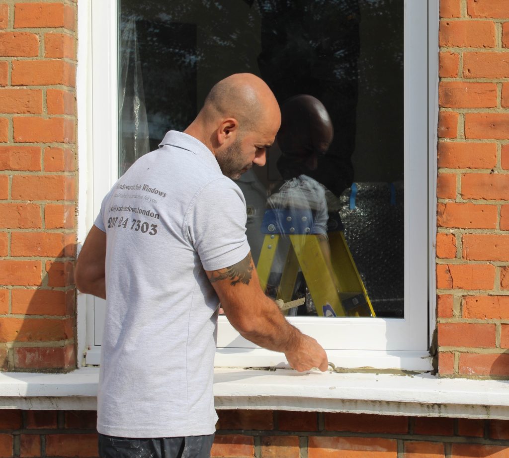 Wandsworth Sash Windows installer working on the installation of a casement window