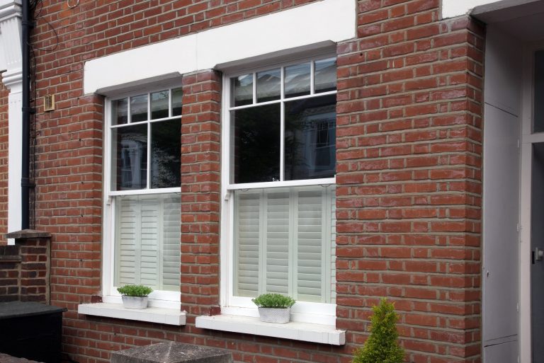 Sliding sash windows which have been repaired - house front view