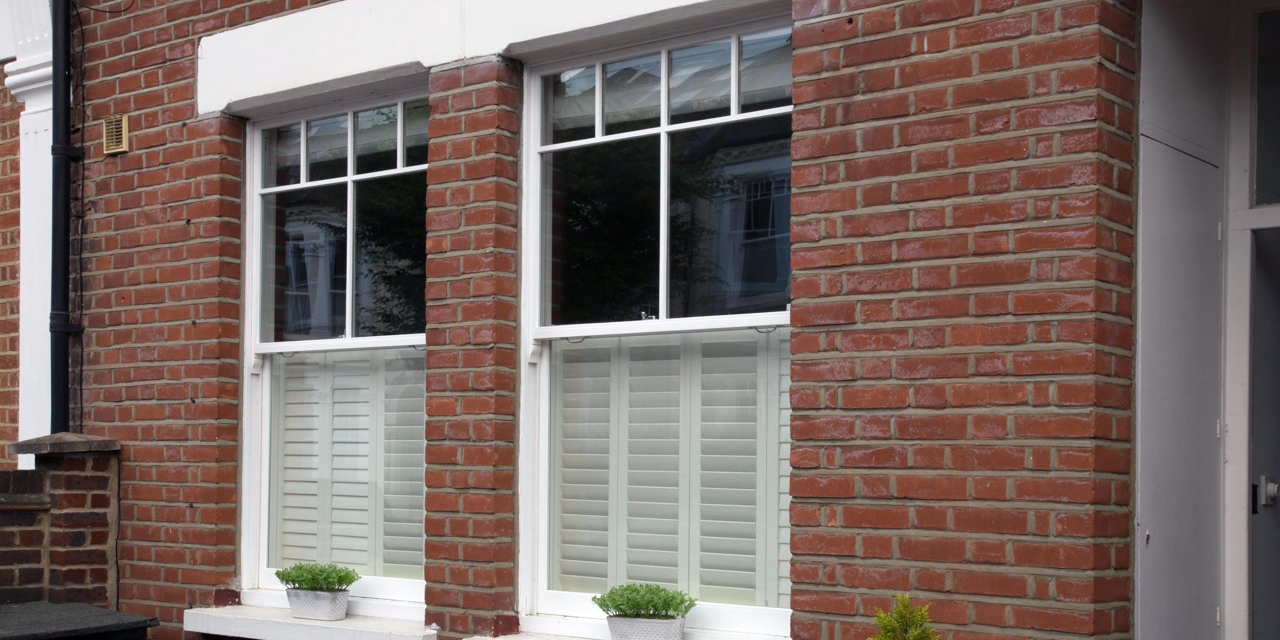 Sliding sash windows which have been repaired - house front view