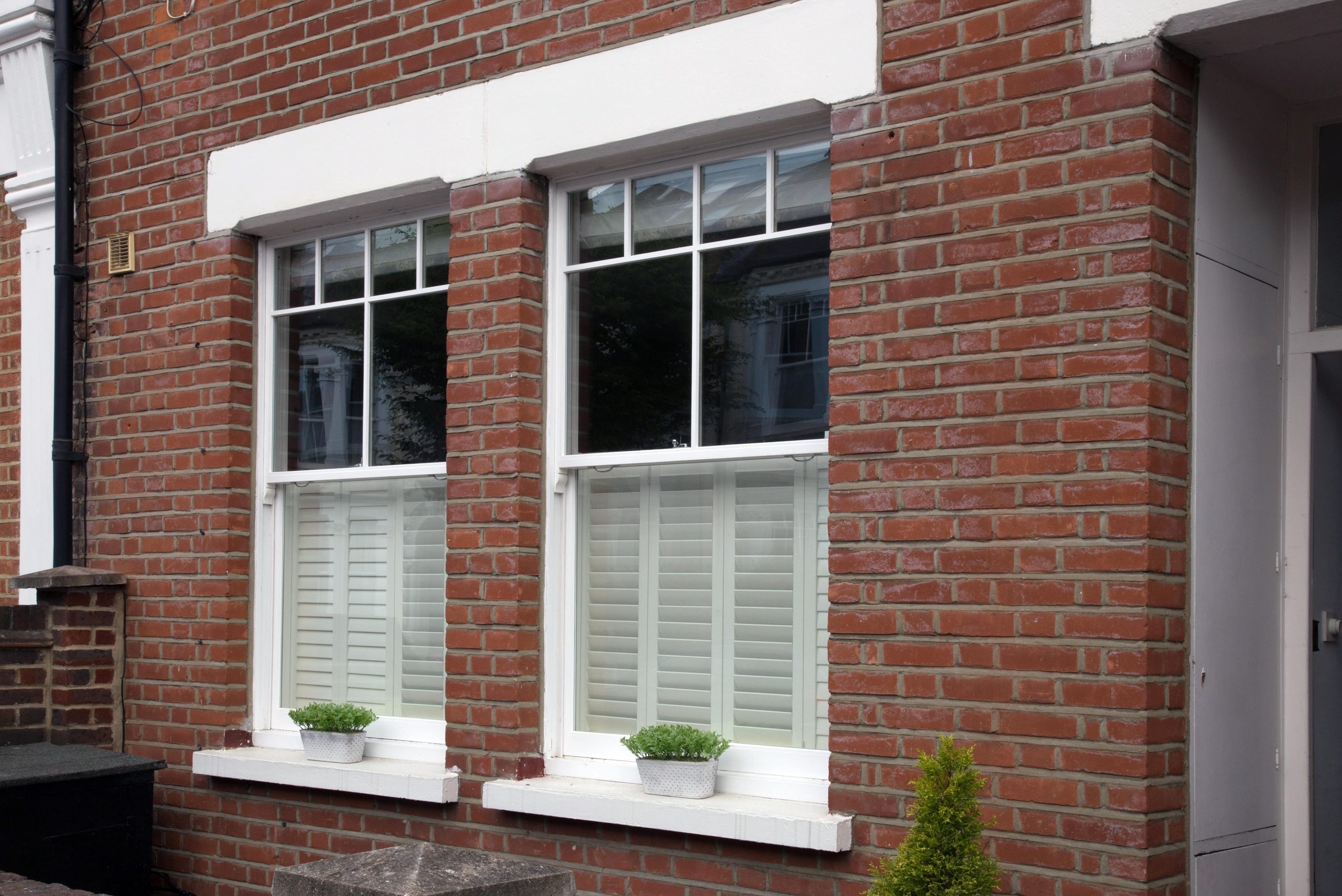 Sliding sash windows which have been repaired - house front view