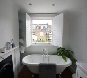 Bathroom sash windows with open shutters Bathroom sash windows with open shutters