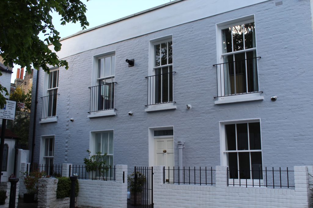 Grey front terraced house with sash windows