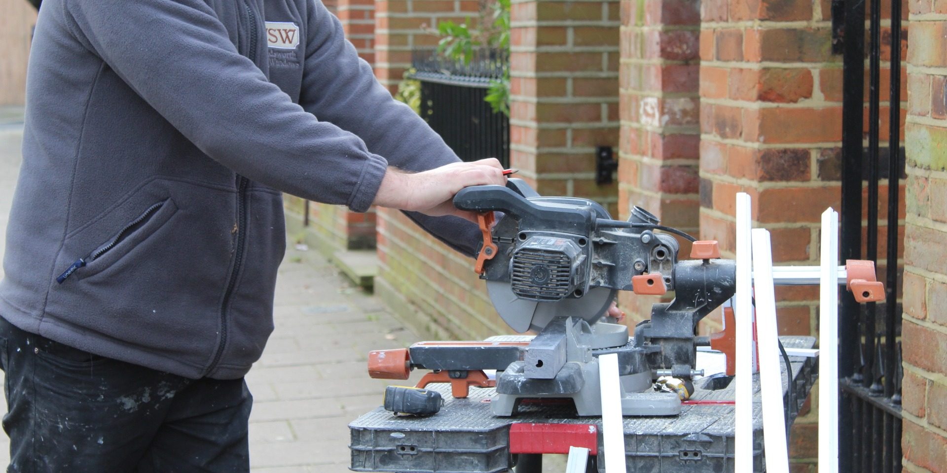 Workman cutting wood for new sash windows Workman cutting wood for new sash windows
