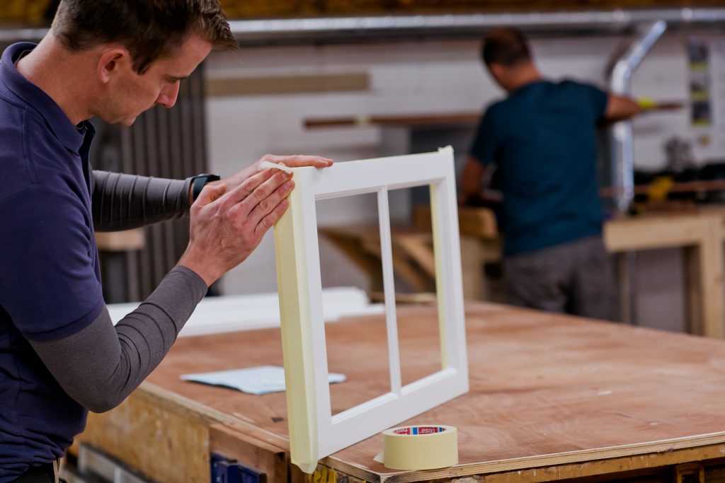 Workman sanding sash window part