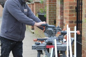 Workman restoring wooden windows