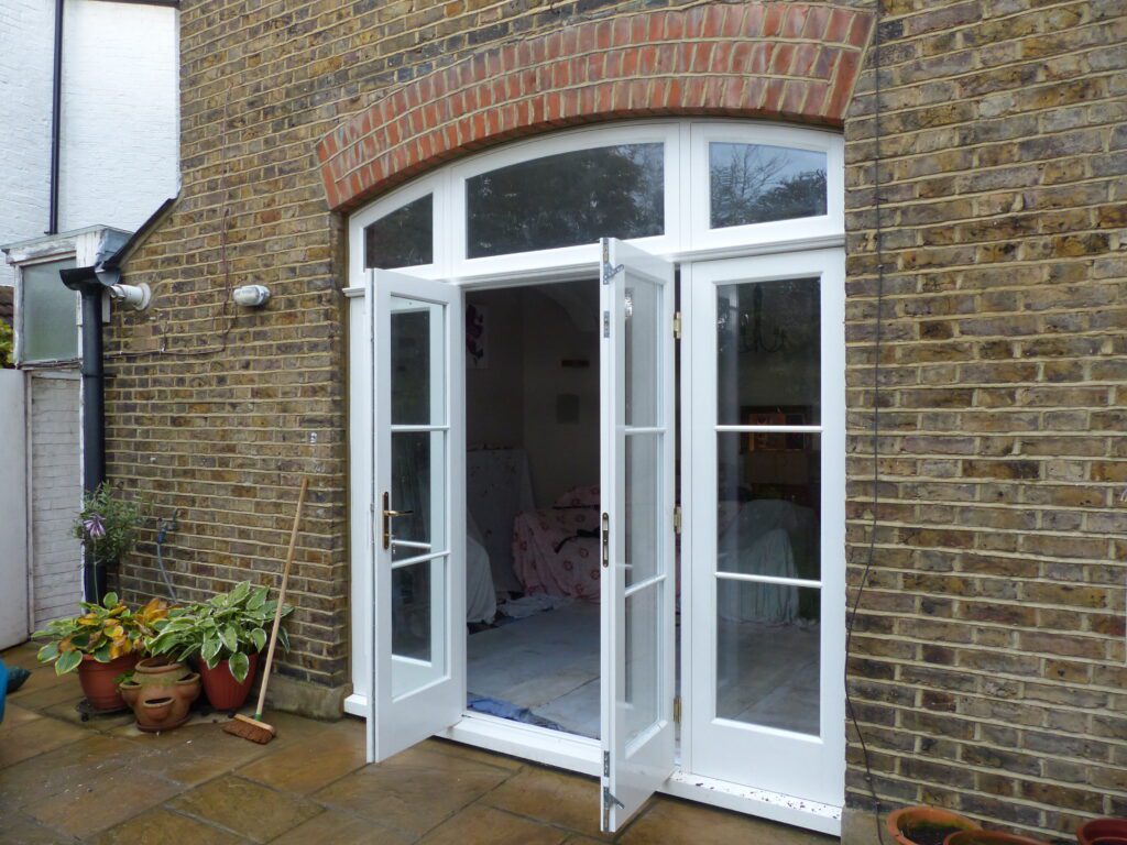 External view of opened timber French doors