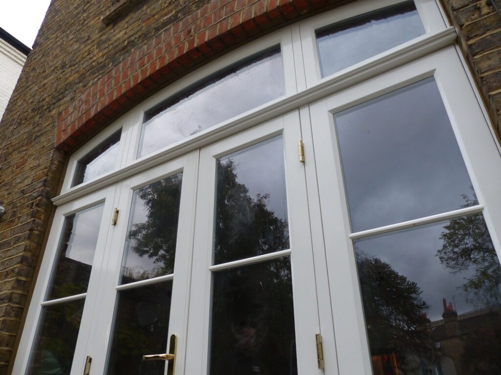 Fanlight of curved timber French doors