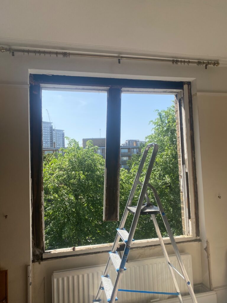Removal of existing timber sash window in progress