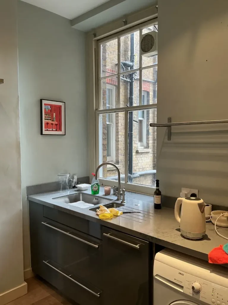 Original single glazed sash window above a kitchen worktop in a Battersea mansion flat