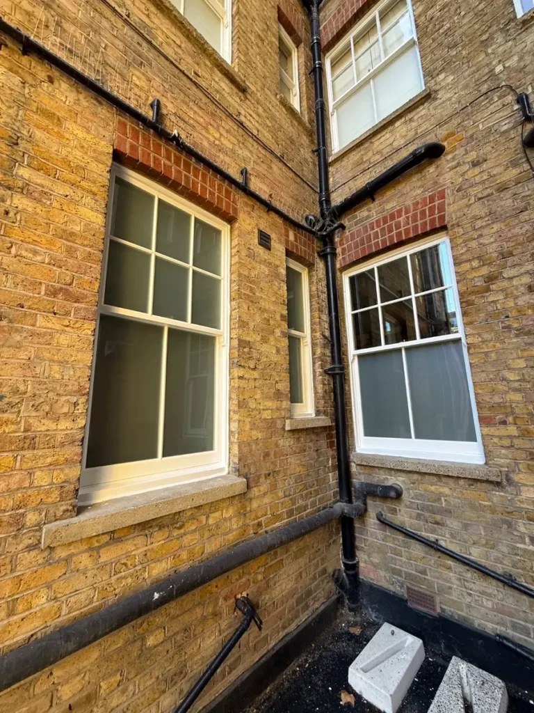 New double glazed sash windows in a mansion block courtyard, Battersea SW11