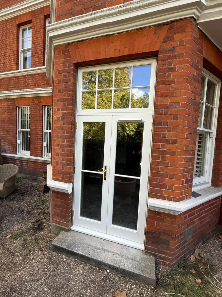 New timber French doors with fanlight in a red brick bay, Prince of Wales Drive, Battersea